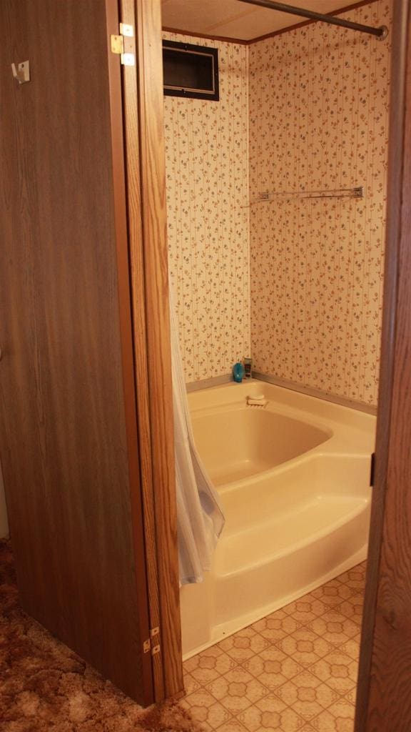 2301 County Road Z Unit 17, Friendship, WI 53934 - full bath featuring a tub to relax in, tile patterned floors, and wallpapered walls