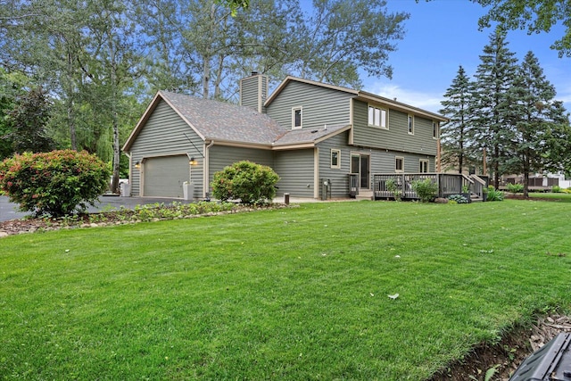 S74W14933 Woods Rd, Muskego, WI 53150 - view of front of house featuring a chimney, a front yard, driveway, an attached garage, and a wooden deck