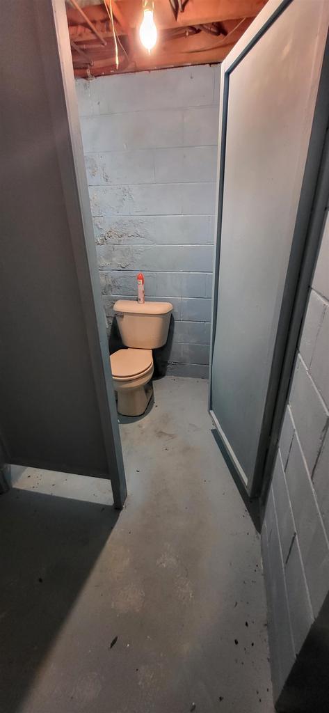 921 S 10th St, Wisconsin Rapids, WI 54494 - bathroom with unfinished concrete flooring and concrete block wall