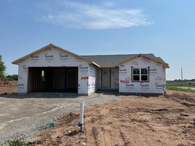 W6645 School Rd, Greenville, WI 54942 - unfinished property with dirt driveway and a garage