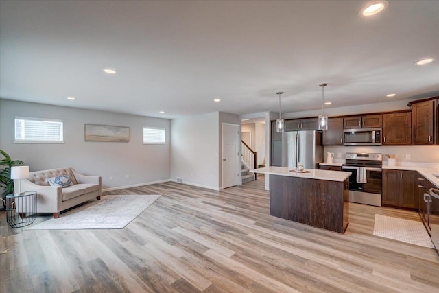 615 Prospect Rd, Waunakee, WI 53597 - kitchen featuring stainless steel appliances, a center island, plenty of natural light, light countertops, and recessed lighting