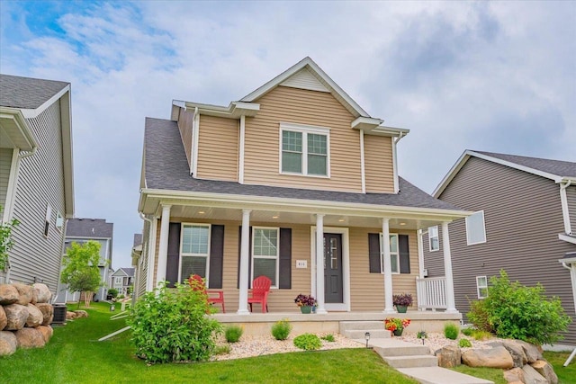 615 Prospect Rd, Waunakee, WI 53597 - view of front facade with covered porch and a front lawn