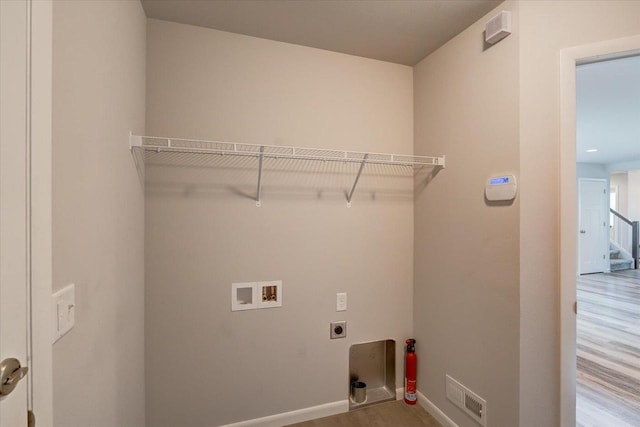 615 Prospect Rd, Waunakee, WI 53597 - laundry area with hookup for a washing machine, hookup for an electric dryer, and wood finished floors