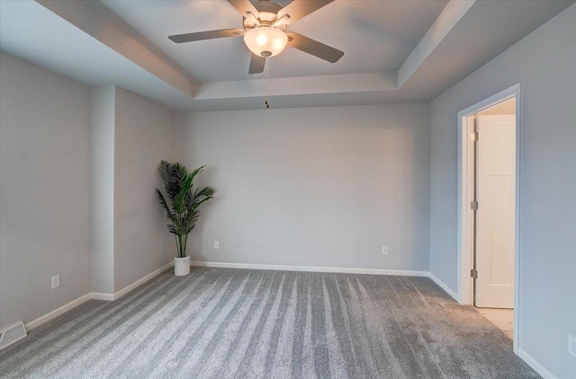615 Prospect Rd, Waunakee, WI 53597 - spare room with a tray ceiling, carpet floors, and ceiling fan