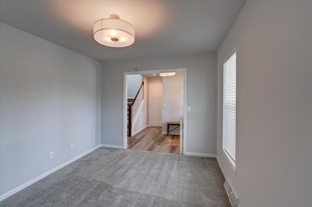 615 Prospect Rd, Waunakee, WI 53597 - carpeted spare room with stairs and baseboards