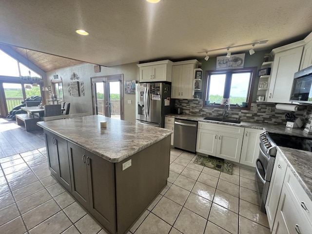 E3577 US Highway 14, Coon Valley, WI 54623 - kitchen with open shelves, stainless steel appliances, backsplash, white cabinetry, and a kitchen island