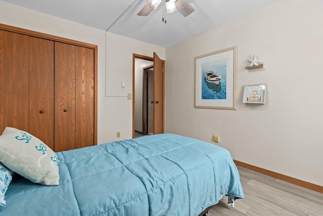 2360 Wisconsin St, Oshkosh, WI 54901 - bedroom with light wood-style floors, ceiling fan, and a closet