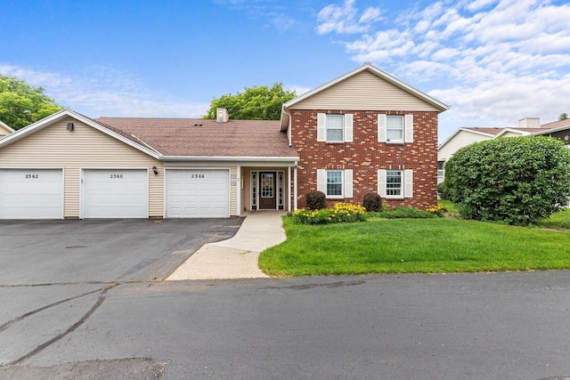 2360 Wisconsin St, Oshkosh, WI 54901 - traditional-style home featuring driveway, a front yard, an attached garage, and brick siding