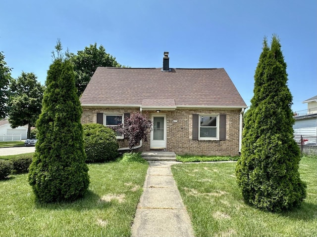 2377 S 76th St, West Allis, WI 53219 - cape cod house with brick siding, a shingled roof, and a chimney