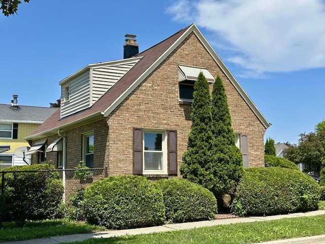 2377 S 76th St, West Allis, WI 53219 - view of side of home with brick siding and a chimney