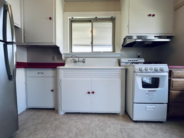 2377 S 76th St, West Allis, WI 53219 - kitchen with extractor fan, white gas range, freestanding refrigerator, and white cabinets