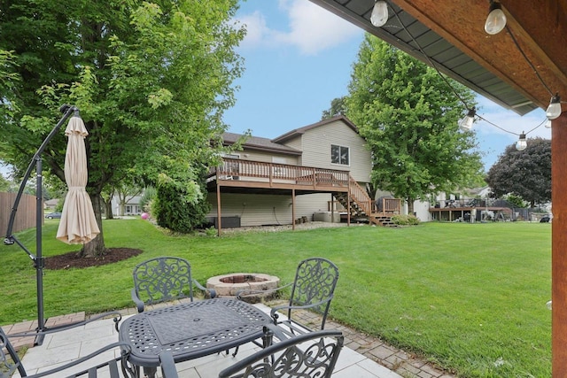 5538 Galway Dr, Waunakee, WI 53597 - view of green lawn featuring an outdoor fire pit, a patio, a wooden deck, and stairway