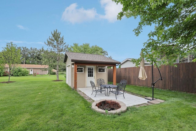 5538 Galway Dr, Waunakee, WI 53597 - fenced backyard featuring a patio area, an outbuilding, and a fire pit
