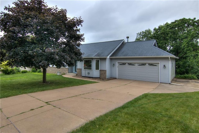 1634 Nicholas Dr, Eau Claire, WI 54703 - view of front facade with a garage, driveway, a front yard, and a shingled roof
