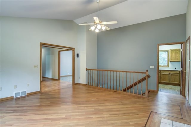 1634 Nicholas Dr, Eau Claire, WI 54703 - empty room featuring light wood finished floors, ceiling fan, and high vaulted ceiling