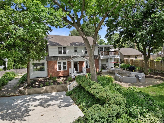 415 S Lake Shore Dr, Lake Geneva, WI 53147 - view of front of home with an outdoor living space, a patio area, brick siding, and a balcony