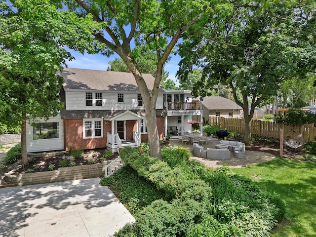 415 S Lake Shore Dr, Lake Geneva, WI 53147 - view of front of house with brick siding, an outdoor living space, a patio, a balcony, and roof with shingles
