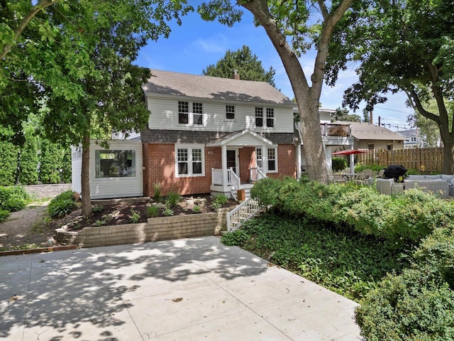 415 S Lake Shore Dr, Lake Geneva, WI 53147 - traditional-style house featuring brick siding and roof with shingles