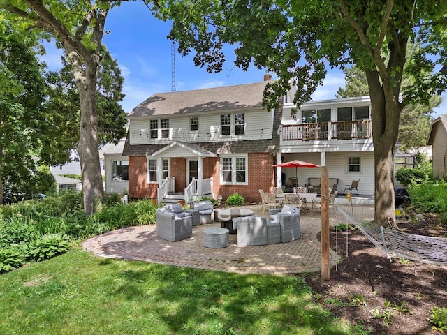 415 S Lake Shore Dr, Lake Geneva, WI 53147 - back of house with outdoor lounge area, a patio area, a balcony, brick siding, and a lawn