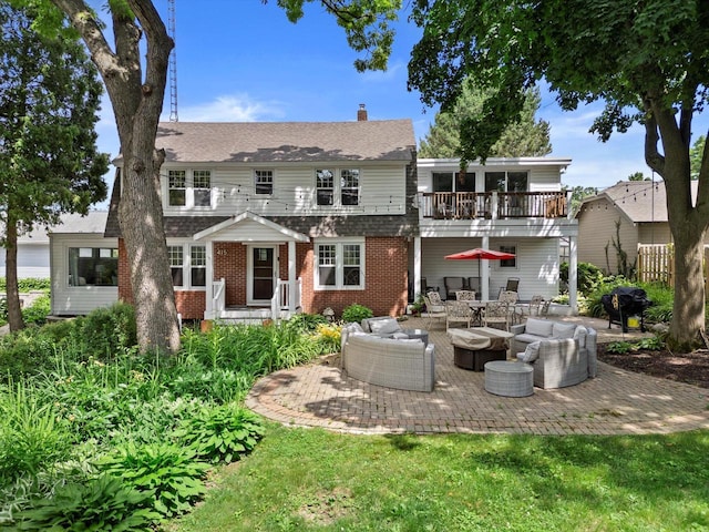 415 S Lake Shore Dr, Lake Geneva, WI 53147 - back of property featuring outdoor lounge area, a balcony, brick siding, a patio, and a chimney
