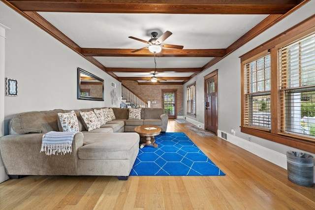 415 S Lake Shore Dr, Lake Geneva, WI 53147 - living area with wood finished floors, beamed ceiling, healthy amount of natural light, a ceiling fan, and stairway