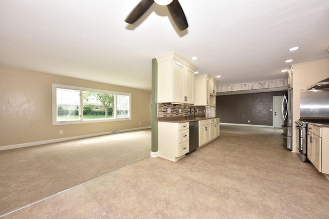 1232 Lambeth Rd, Waukesha, WI 53189 - kitchen with stainless steel appliances, light colored carpet, dark countertops, a ceiling fan, and backsplash