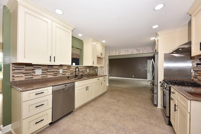 1232 Lambeth Rd, Waukesha, WI 53189 - kitchen featuring stainless steel appliances, cream cabinetry, decorative backsplash, recessed lighting, and wall chimney range hood