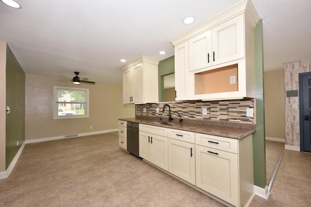 1232 Lambeth Rd, Waukesha, WI 53189 - kitchen with stainless steel dishwasher, ceiling fan, backsplash, dark countertops, and light carpet