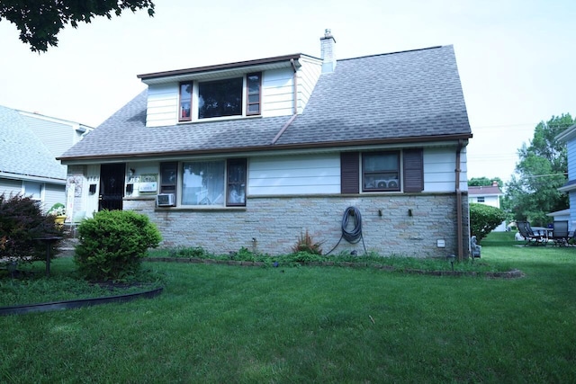 8761 W Herbert Ave, Milwaukee, WI 53225 - view of front of house with stone siding, a front lawn, roof with shingles, and a chimney