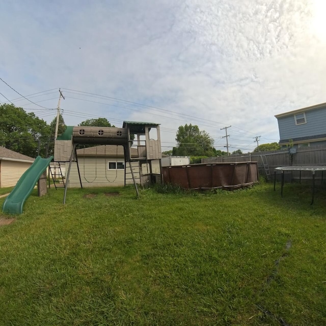 8761 W Herbert Ave, Milwaukee, WI 53225 - view of yard featuring a playground and a trampoline