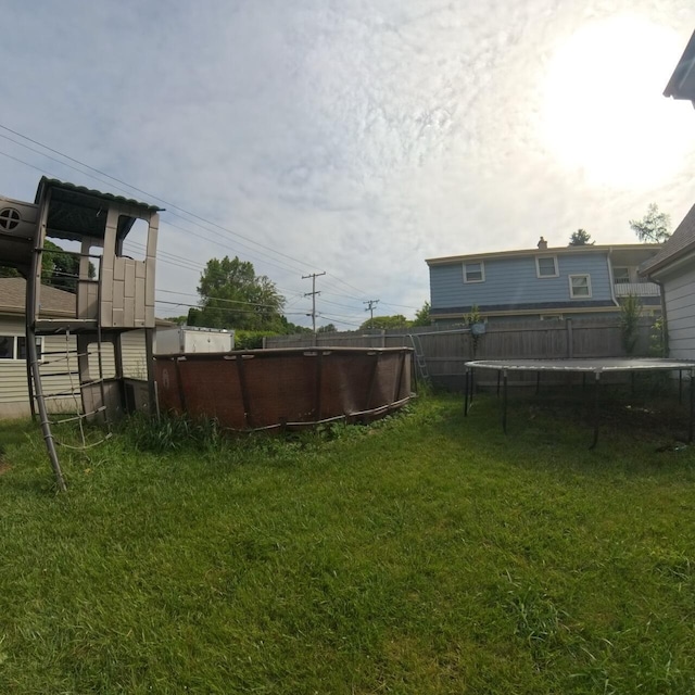 8761 W Herbert Ave, Milwaukee, WI 53225 - view of yard with a trampoline and a swimming pool