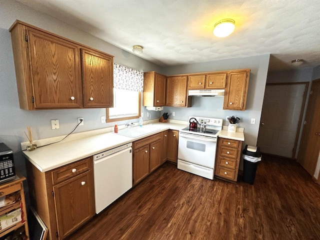 2354 Daylily Ct, Beloit, WI 53511 - kitchen featuring white appliances, under cabinet range hood, dark wood finished floors, brown cabinets, and light countertops