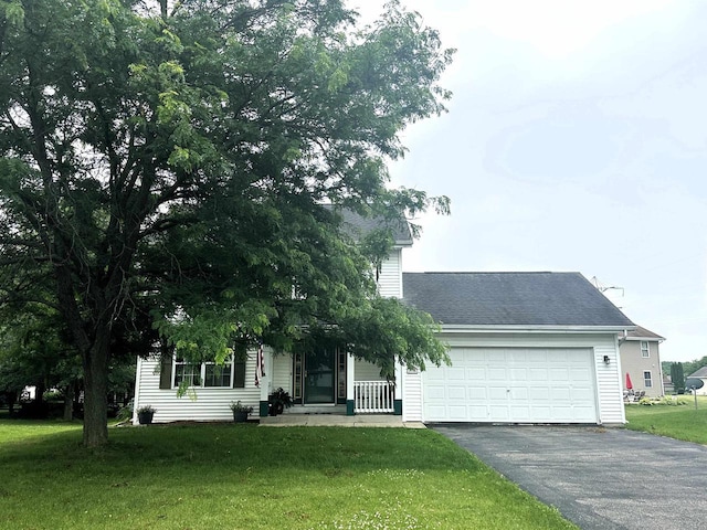 2354 Daylily Ct, Beloit, WI 53511 - view of property hidden behind natural elements featuring driveway, a front lawn, an attached garage, and a shingled roof