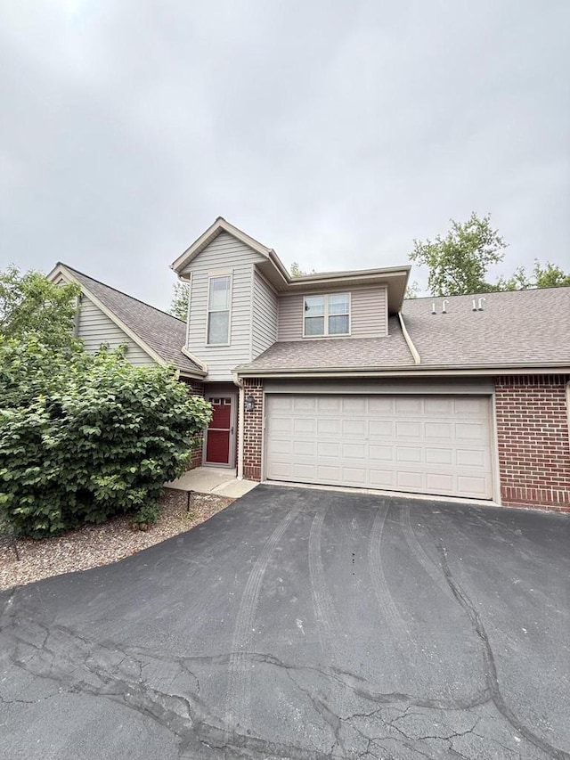 N82W13370 Fond Du Lac Ave Unit 101, Menomonee Falls, WI 53051 - traditional-style house with driveway and brick siding