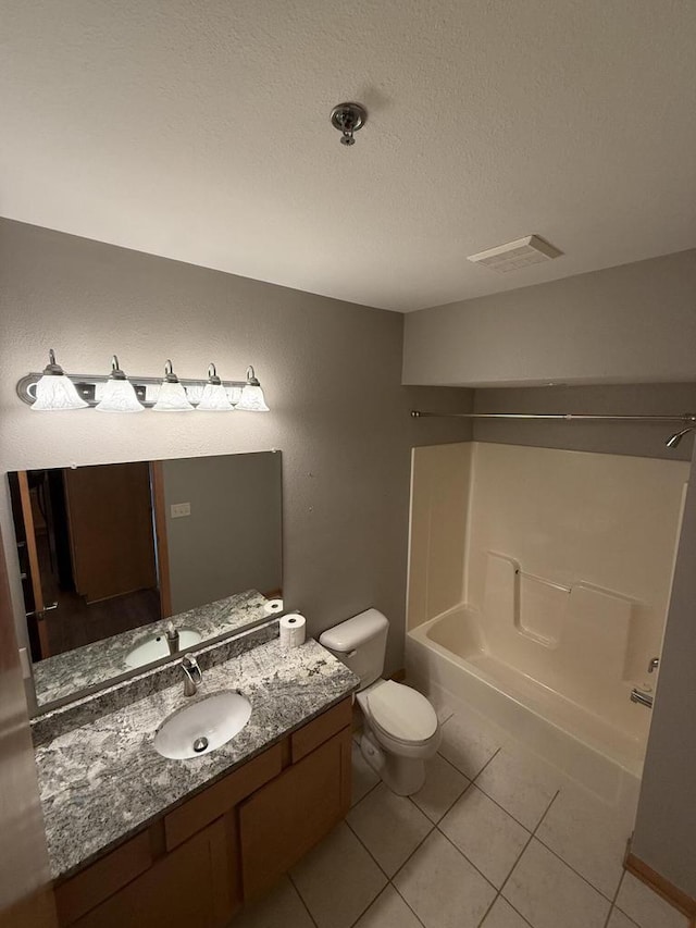 N82W13370 Fond Du Lac Ave Unit 101, Menomonee Falls, WI 53051 - full bath with vanity, tile patterned floors, shower / bath combination, and a textured ceiling