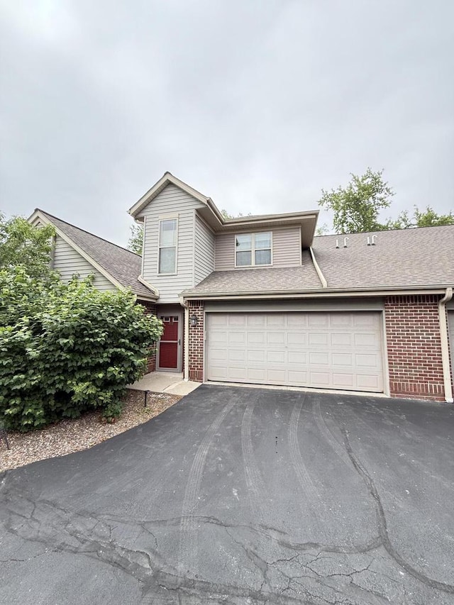 N82W13370 Fond Du Lac Ave Unit 101, Menomonee Falls, WI 53051 - traditional home featuring brick siding, driveway, and a garage