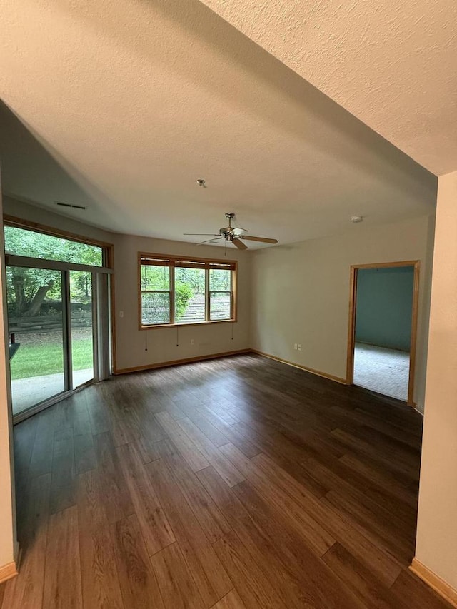 N82W13370 Fond Du Lac Ave Unit 101, Menomonee Falls, WI 53051 - empty room with a textured ceiling, ceiling fan, and dark wood-type flooring