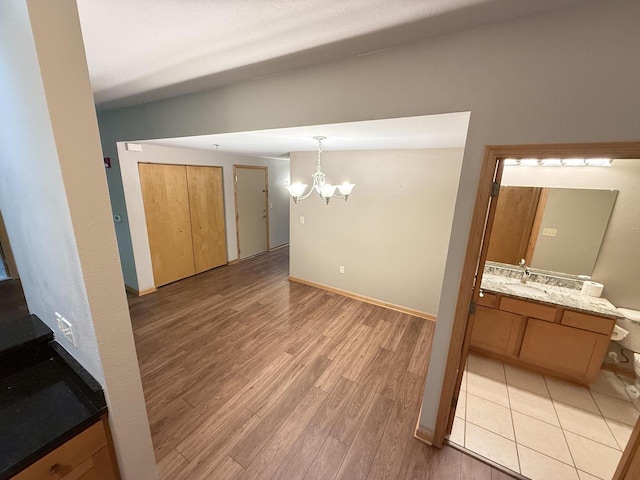 N82W13370 Fond Du Lac Ave Unit 101, Menomonee Falls, WI 53051 - unfurnished dining area featuring a chandelier and light wood-type flooring