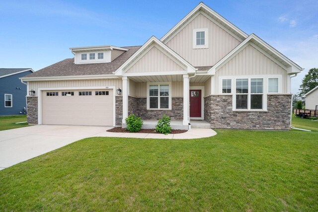 520 Meadow View Dr, Slinger, WI 53086 - craftsman-style house with stone siding, a garage, a front yard, a porch, and concrete driveway