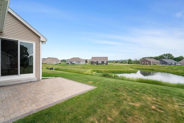520 Meadow View Dr, Slinger, WI 53086 - view of green lawn featuring a patio, a water view, and a residential view