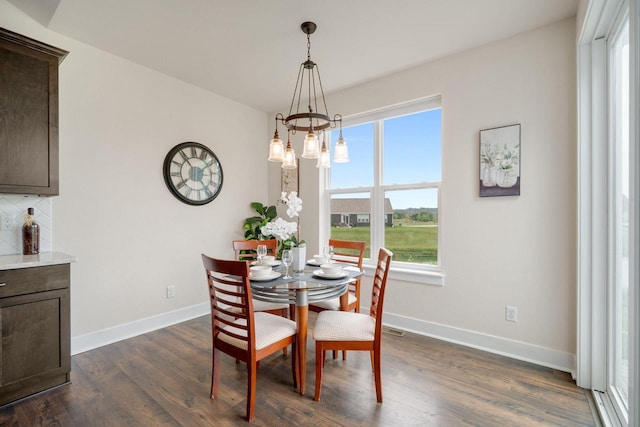 520 Meadow View Dr, Slinger, WI 53086 - dining area with dark wood finished floors and a chandelier