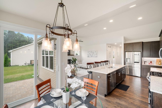 520 Meadow View Dr, Slinger, WI 53086 - kitchen with stainless steel appliances, dark brown cabinetry, recessed lighting, a center island with sink, and dark wood-style floors