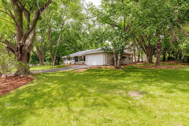 15300 Clifford Ct, Brookfield, WI 53005 - view of grassy yard featuring asphalt driveway and an attached garage