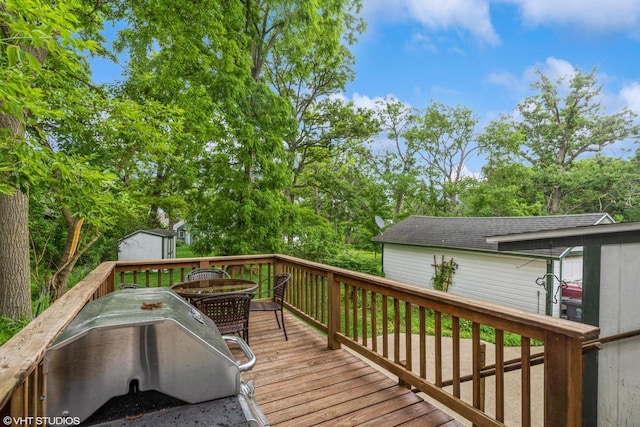 W3632 Oakrest Ave, Lake Geneva, WI 53147 - wooden deck with grilling area, outdoor dining area, and a storage shed