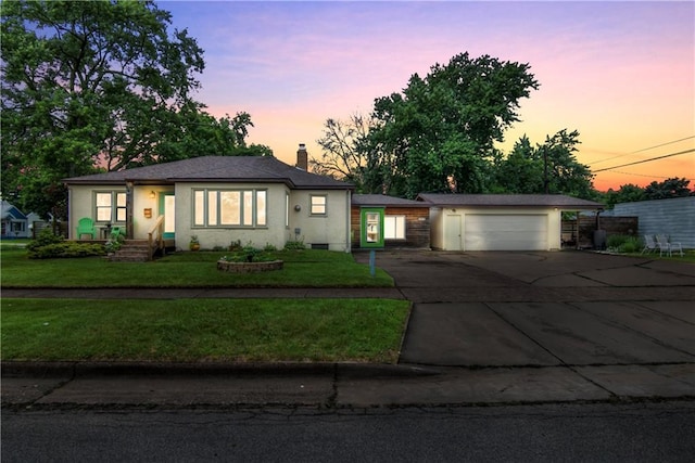 1418 Keith St, Eau Claire, WI 54701 - view of front of house featuring a chimney, asphalt driveway, an attached garage, and a lawn