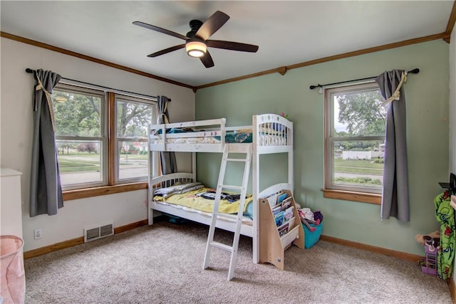 1418 Keith St, Eau Claire, WI 54701 - carpeted bedroom with ornamental molding, multiple windows, and ceiling fan