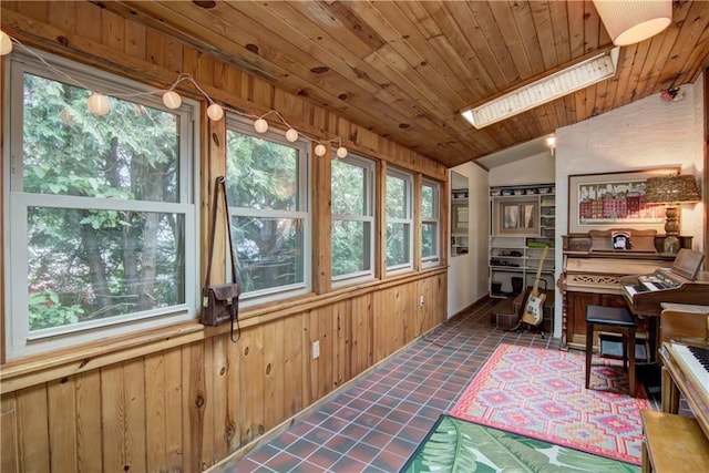 1418 Keith St, Eau Claire, WI 54701 - sunroom with a skylight, lofted ceiling, wood walls, wood ceiling, and tile patterned flooring