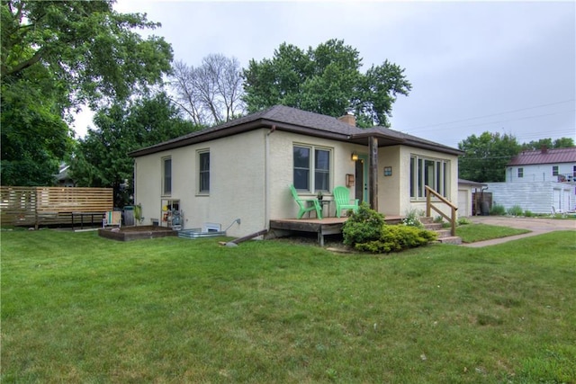 1418 Keith St, Eau Claire, WI 54701 - view of front facade with stucco siding, a chimney, and a garage