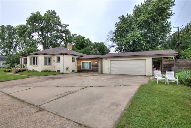 1418 Keith St, Eau Claire, WI 54701 - view of front of property with driveway, a garage, and a chimney