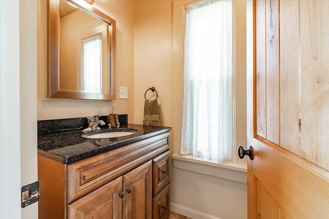 117 6th St, Nekoosa, WI 54457 - bathroom featuring vanity and healthy amount of natural light
